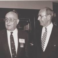 Bill Seidman standing with Richard DeVos.